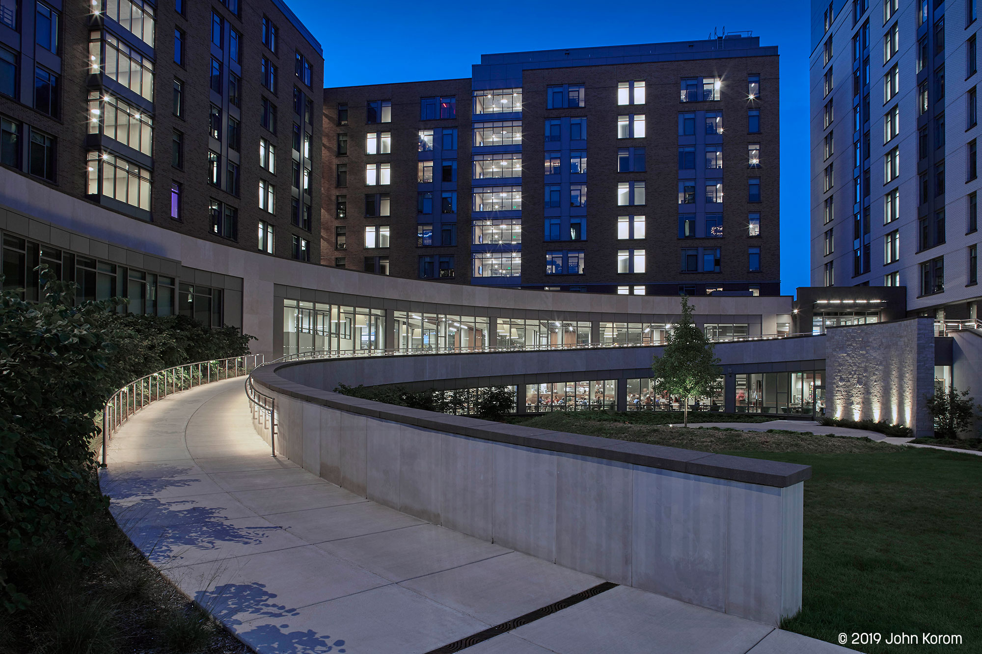 Marquette Commons at Marquette University in Milwaukee, featuring Lumenrail Lumenlinear illuminated pathway at dusk.